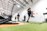 Group of youths exercise in indoor training facility